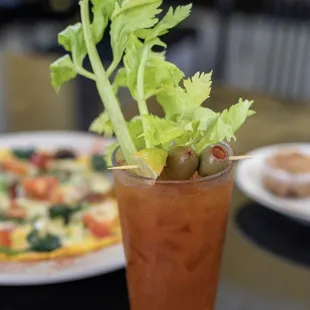 a bloody drink with celery garnish
