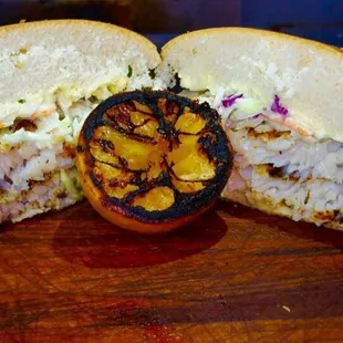 a sandwich cut in half with a side of coleslaw