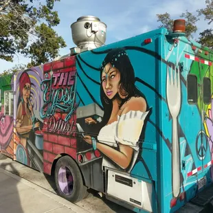 a woman with a skull on the side of a food truck
