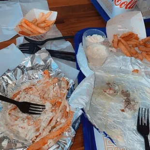 Post-demolition of a #1 combo w/greek fries &amp; two #2 combos, one with greek fry toppings on the side.