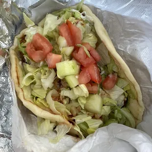 a taco with lettuce and tomatoes