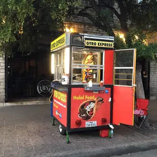 a hot dog cart on a city street