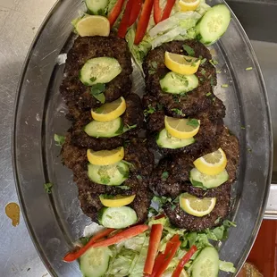 a platter of meat and vegetables