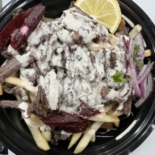a bowl of fries and meat