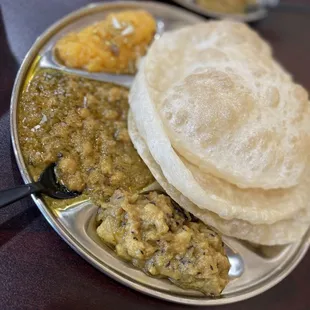 Halwa Puri (3 puri, garbanzo curry, potato curry and yellow Halwa (dessert). This food is enough for all day.