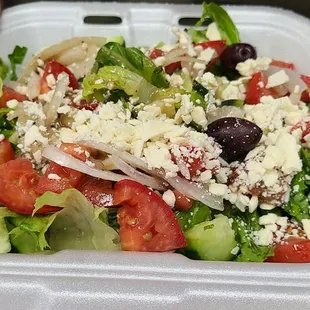 a salad in a styrofoam container