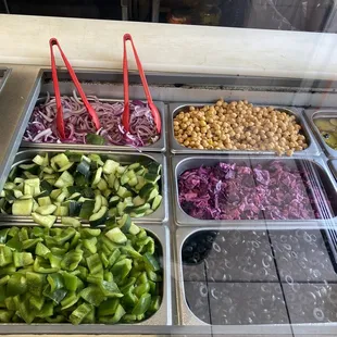 a variety of vegetables in trays