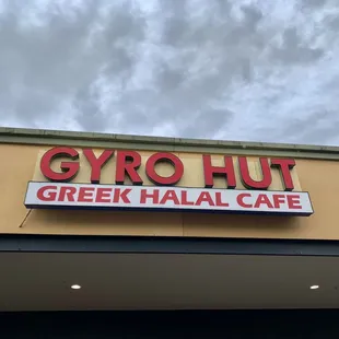 a sign for a greek halal cafe