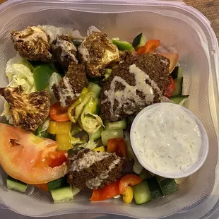 &quot;Veggie Garden&quot; except it&apos;s just a single falafel cut into a couple pieces and some burnt cauliflower with tzatziki sauce.