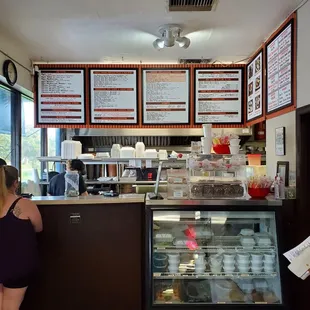a woman standing in front of a counter