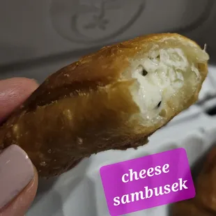 a hand holding a half eaten doughnut