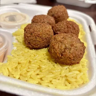 three meatballs on a bed of rice