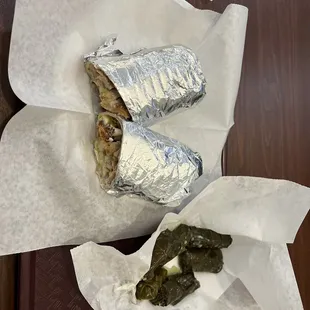a burrito and a pickle on a tray