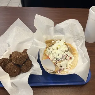 a tray of food and a cup of coffee