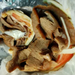 a beef sandwich cut in half