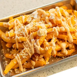 Feta Fries drizzled with house sauce.