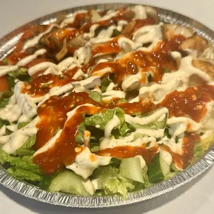 Spicy Combo Bowl (Chicken and Gyro) with house sauce and spicy sauce.