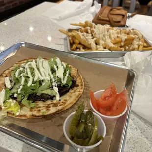 Smash pita extra tomatoes, extra pickles, and feta fries delicious thank you