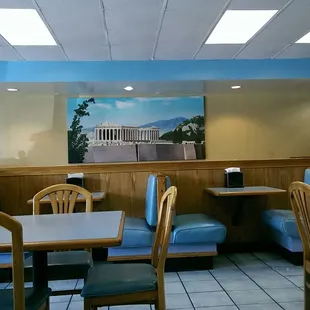 a view of a dining room with blue chairs