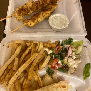 Open face souvlaki chicken meal.