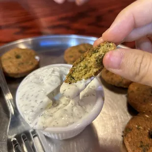 Cross section of falafel in tzatziki sauce