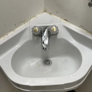 This men's bathroom sink is barely functional