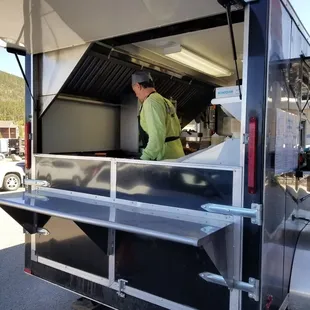 a man preparing food in a food truck