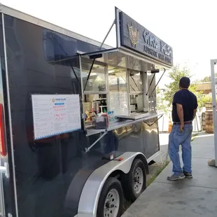 a man standing in front of a food truck