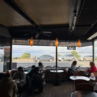 Indoor seating with a view.  There is also a single bench outside on the sidewalk.