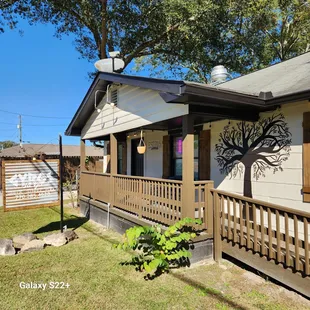 a house with a tree on the front porch