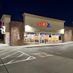 the exterior of a grocery store at night