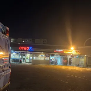 a car parked in front of a gas station at night