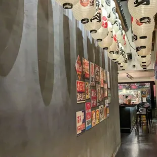 a hallway with lanterns hanging from the ceiling