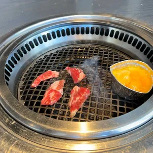 Prime Kalbi grilling with some cheese fondue heating up
