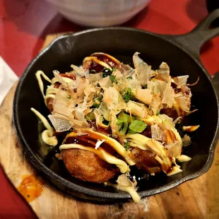 Takoyaki is served in a skillet, but it is only mildly warm   It has happy hour discount, but it tasted only ok.