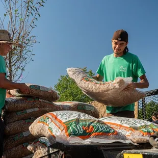 two people loading bags of food
