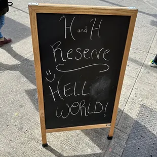 a chalk board on a sidewalk
