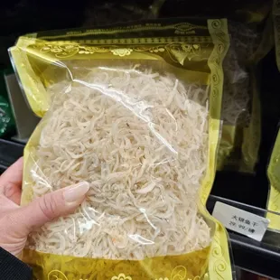 a person holding a bag of noodles