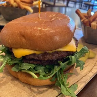 a cheeseburger with lettuce and pickles