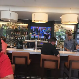 two men sitting at the bar