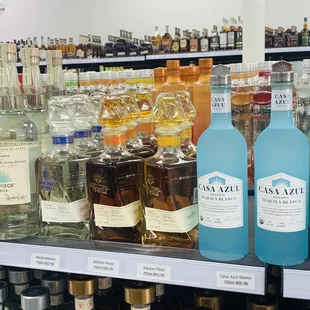 bottles of alcohol on a shelf in a liquor store