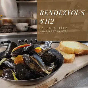 a bowl of mussels and bread