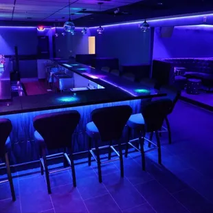 a bar with purple lighting