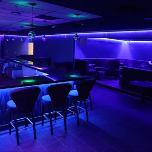 a bar with purple lighting