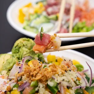 two plates of food with chopsticks