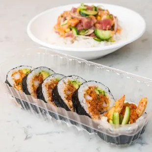 a plate of sushi and a plate of shrimp