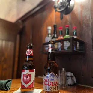 two bottles of beer on a table