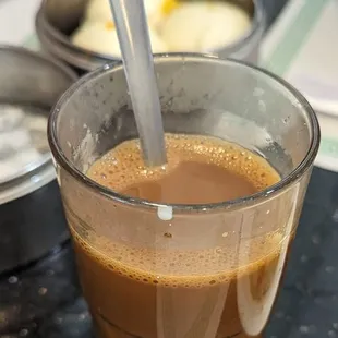 a cup of coffee with a spoon in it