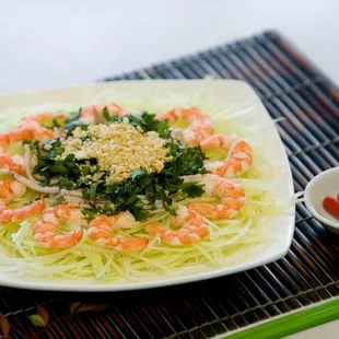 Vietnamese Green Papaya Salad with Shrimp, Pork, chopped basil and culantro topped with roasted peanuts.