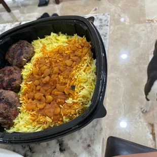 a black and white dog looking at a plate of food